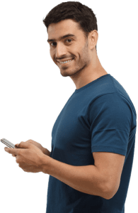 Man smiling in a blue shirt holding a phone