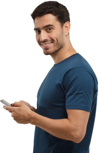 Man smiling in a blue shirt holding a phone
