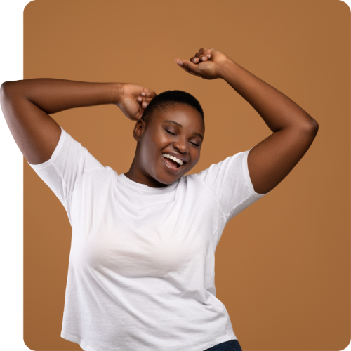 Joyful woman stretching and smiling against a brown background, representing the freedom and peace of mind that comes with free PrEP and Doxy-PEP from Q Care Plus.